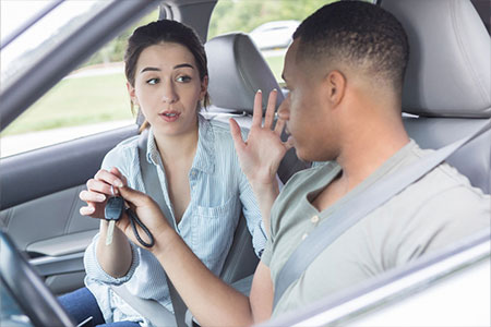 teen passenger taking keys from teen driver