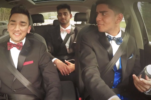 3 guys in a car dressed for prom