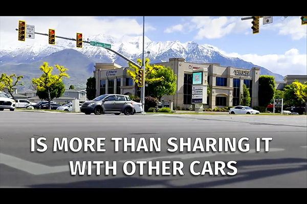 street with the text sharing the road is more than sharing the road with cars