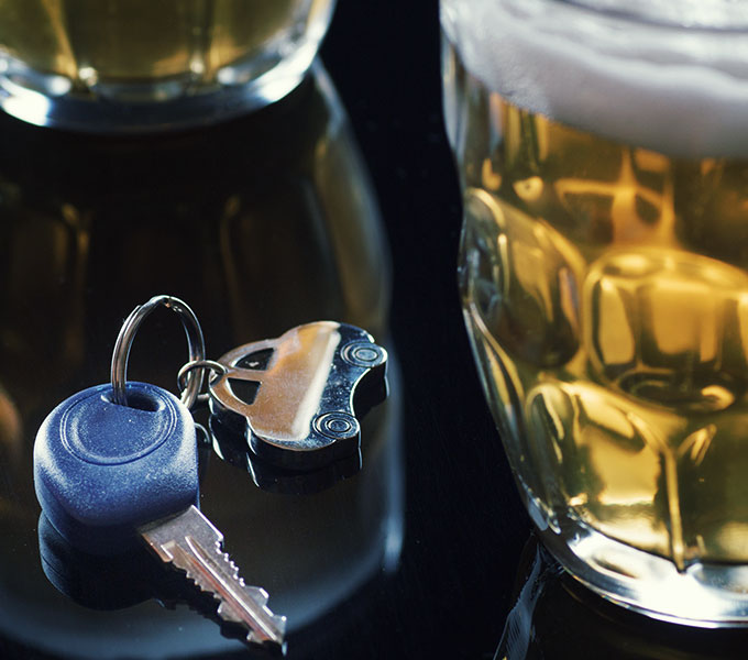 beer glass and car keys on a table