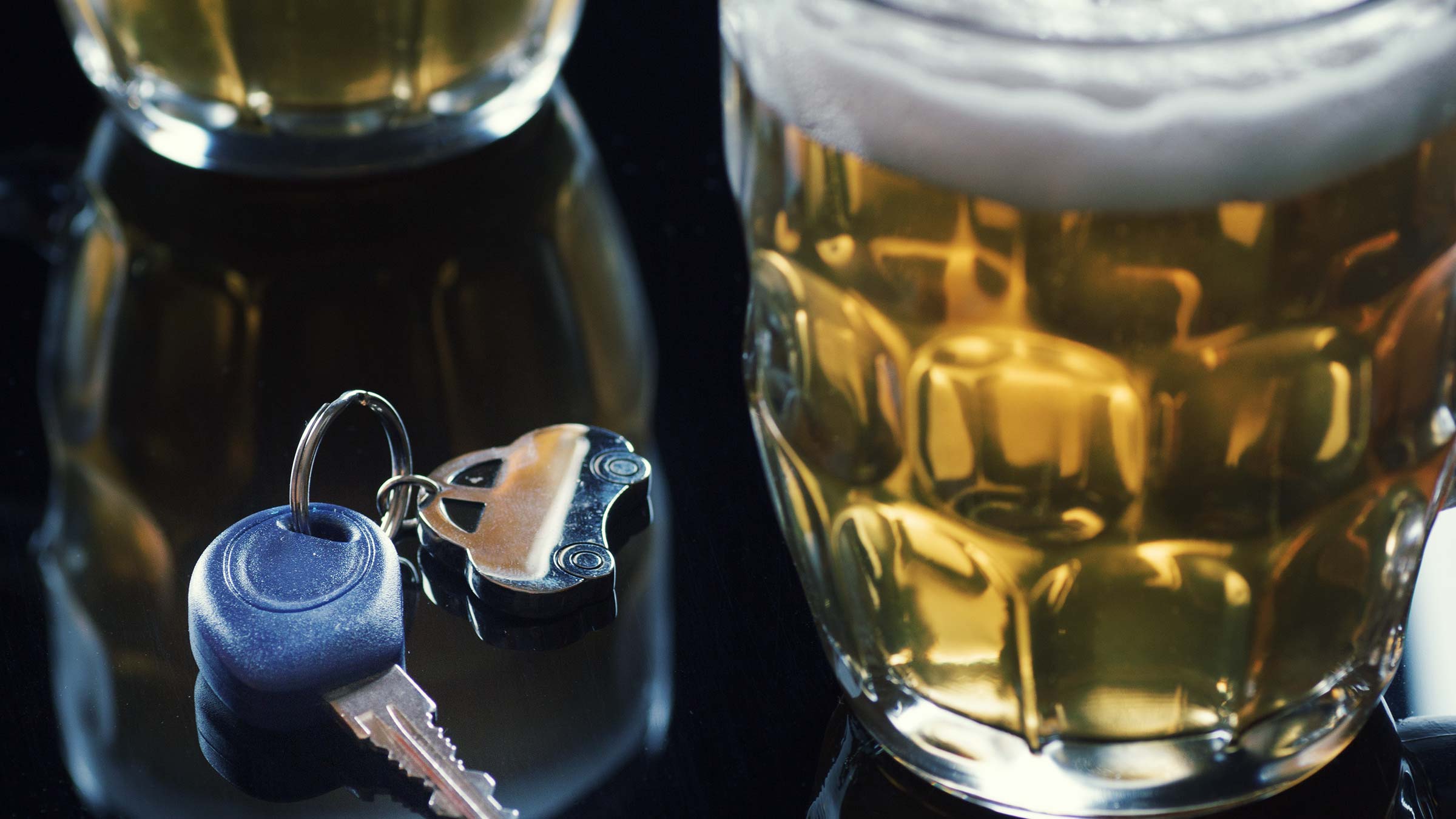 beer glass and car keys on a table