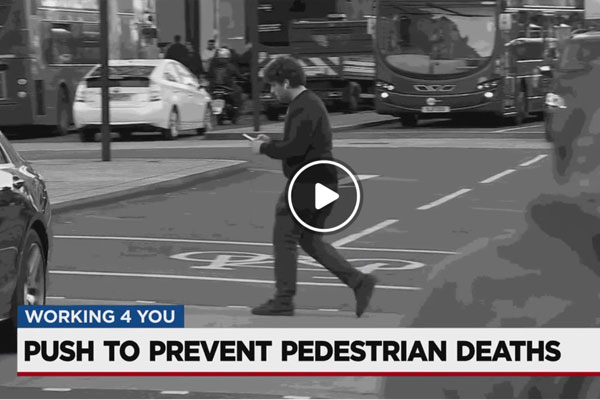 Push to prevent pedestrian deaths in Nashville - guy walking across the street looking at his phone