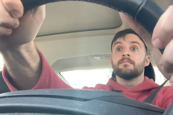 under view of a man holding a steering wheel