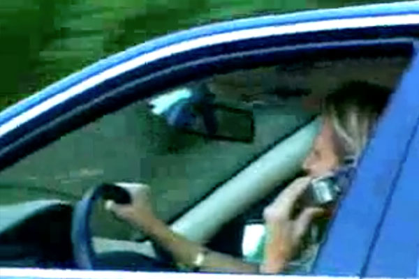 woman driving talking on her cell phone