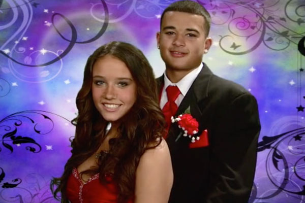 a teen couple at prom smiling with a purple background